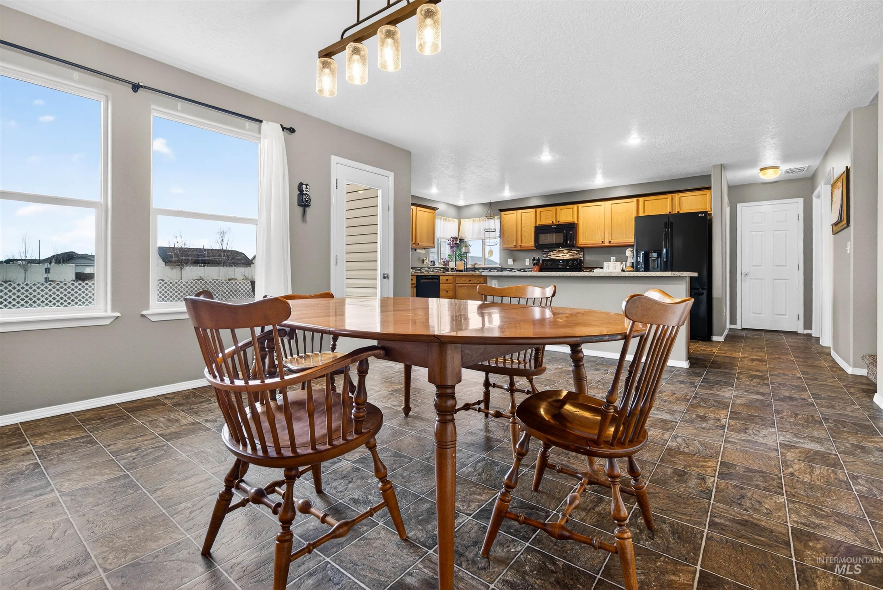 5414 Barkley Way Caldwell, ID 83607 - Photo 14 of 50 Dining room featuring dark stone finish floors and recessed lighting