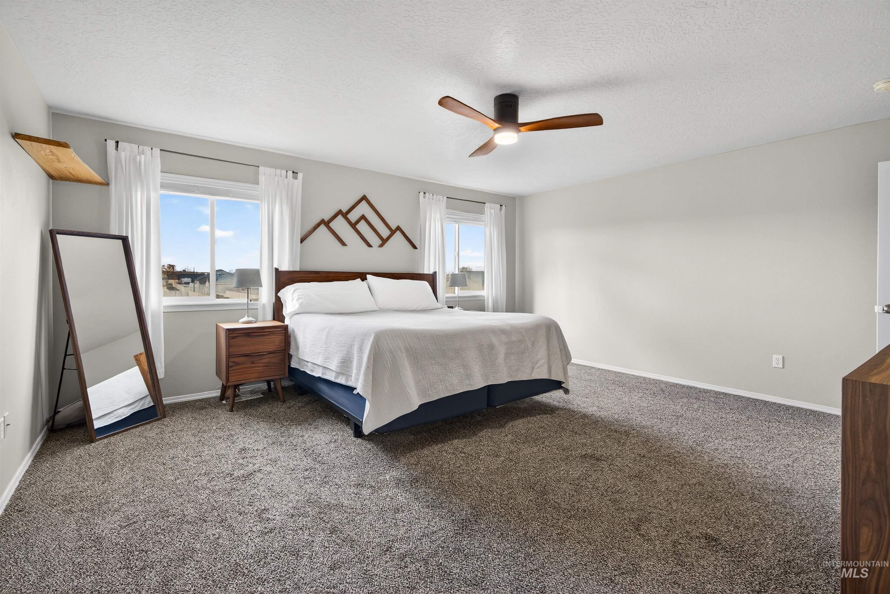 5414 Barkley Way Caldwell, ID 83607 - Photo 18 of 50 Carpeted bedroom with a textured ceiling and a ceiling fan
