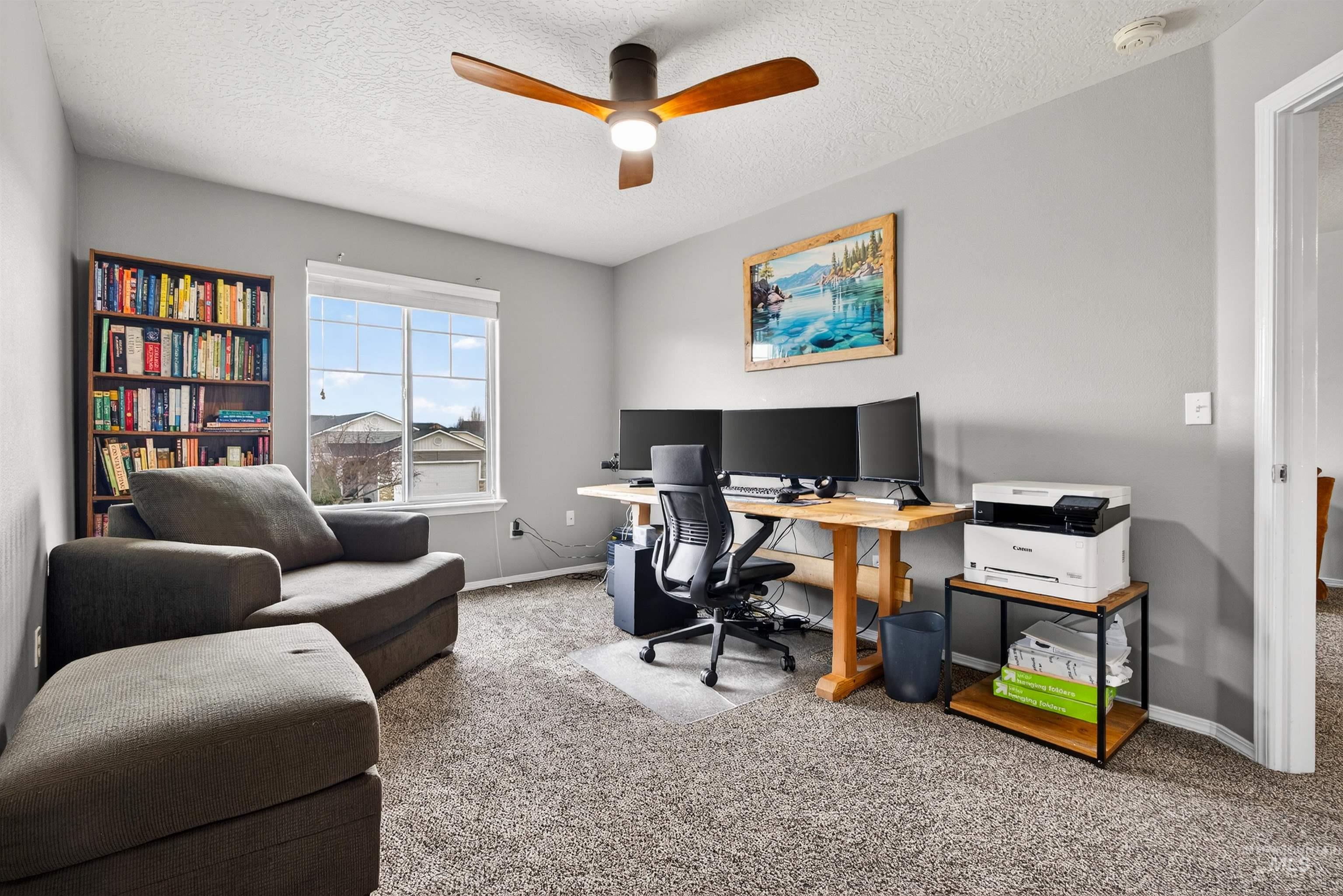 5414 Barkley Way Caldwell, ID 83607 - Photo 23 of 50 Home office with carpet floors, ceiling fan, and a textured ceiling