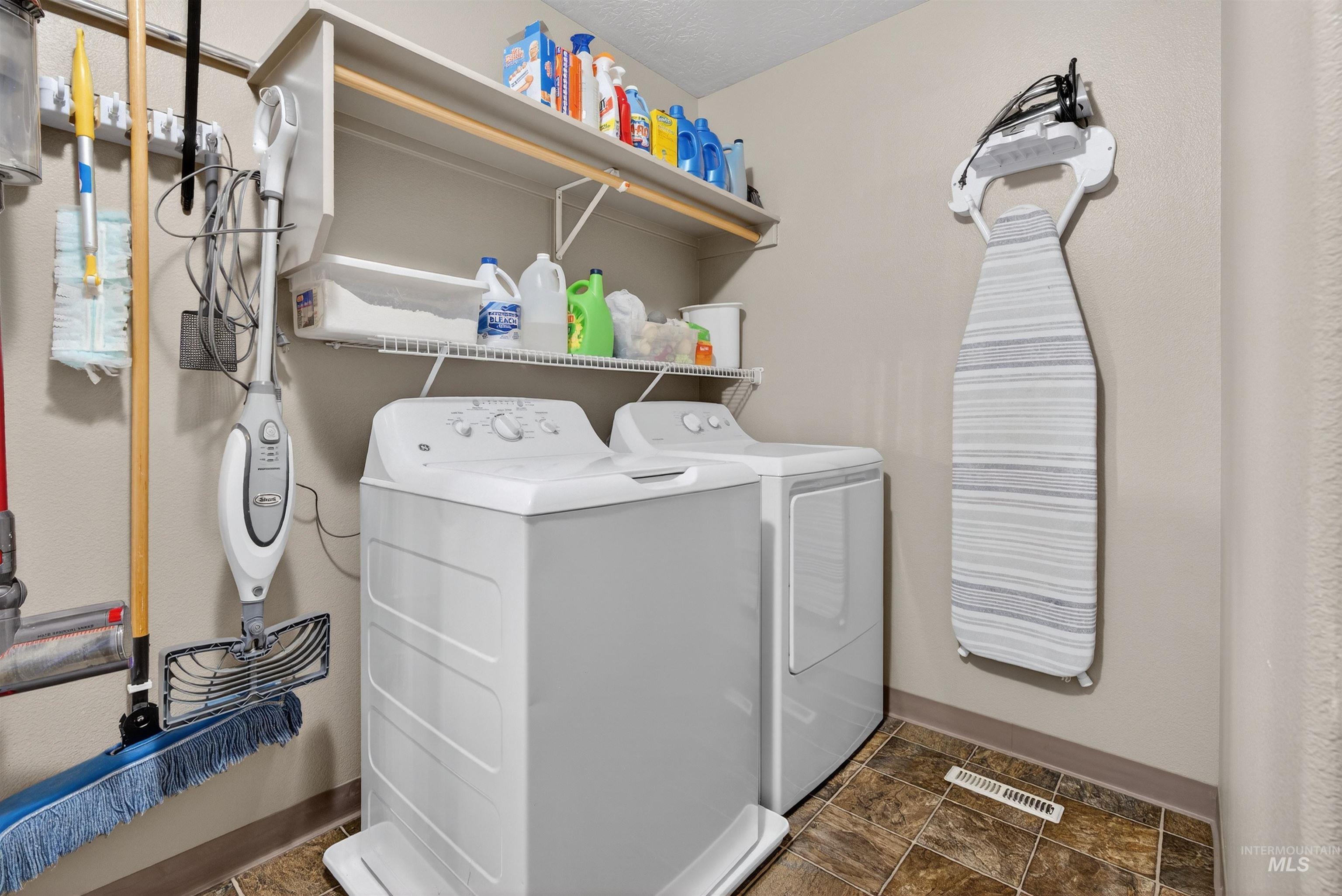 5414 Barkley Way Caldwell, ID 83607 - Photo 30 of 50 Laundry area with washer and clothes dryer and stone finish floors