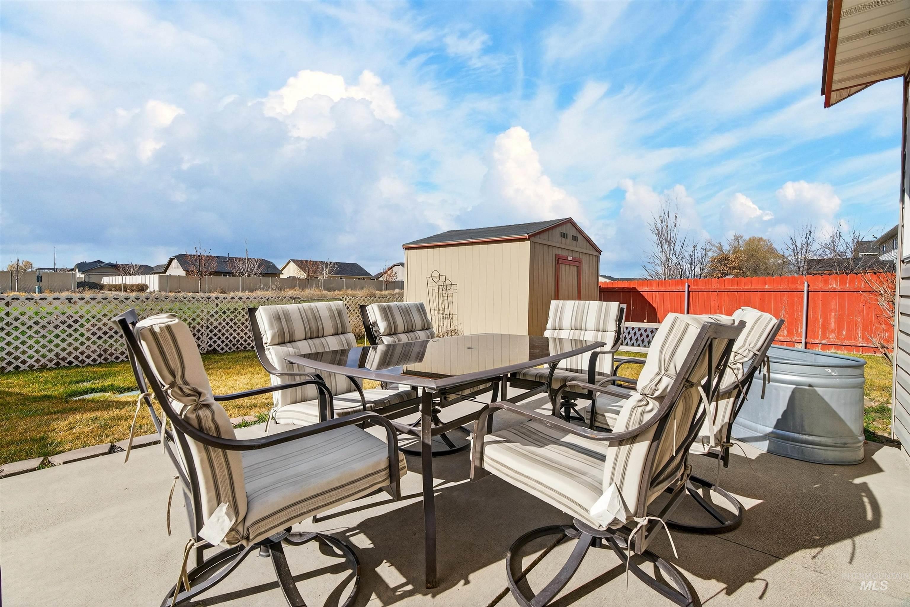 5414 Barkley Way Caldwell, ID 83607 - Photo 34 of 50 Fenced backyard with a shed, outdoor dining area, a patio, and a residential view