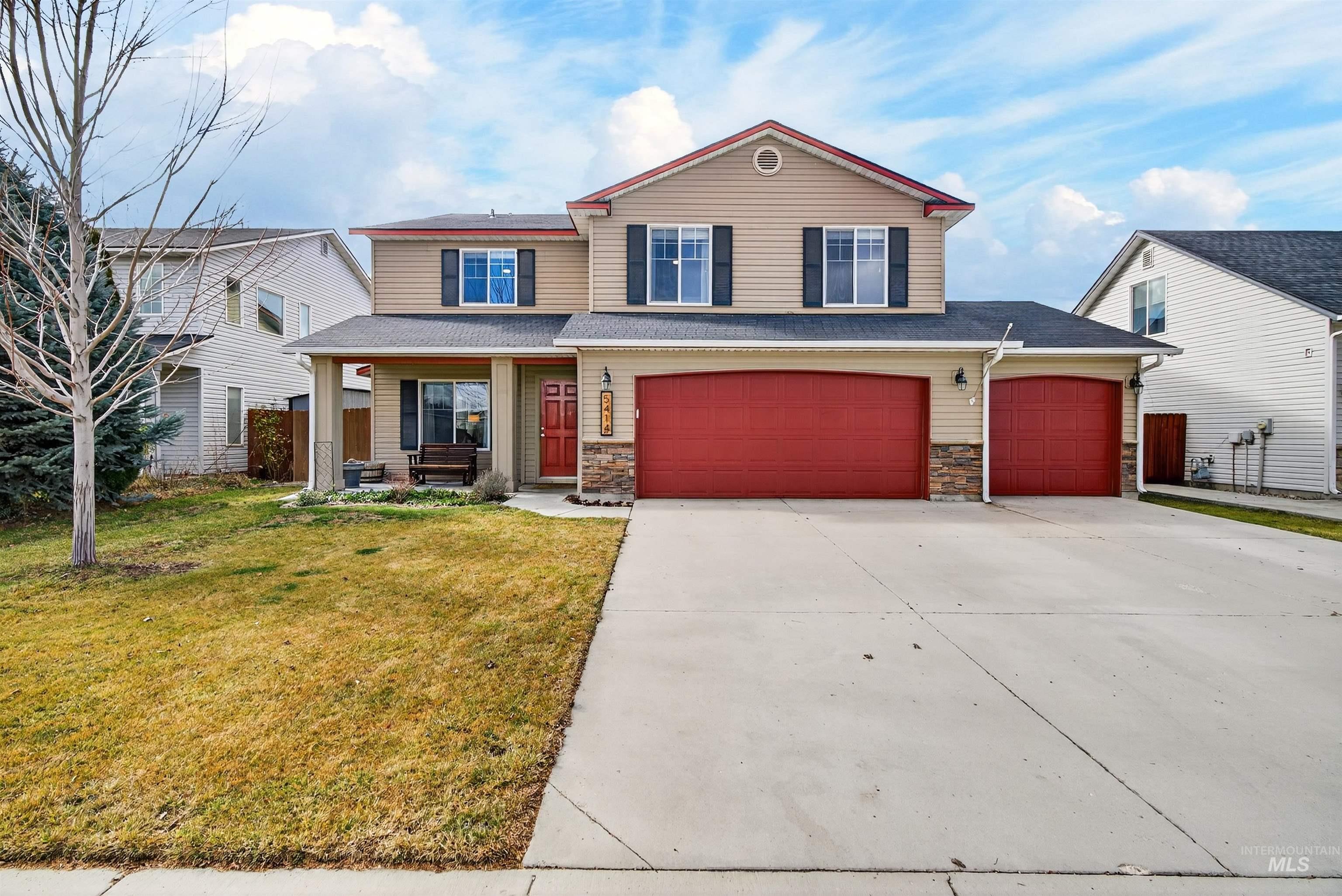 5414 Barkley Way Caldwell, ID 83607 - Photo 37 of 50 View of front facade featuring a porch, a front lawn, concrete driveway, and stone siding
