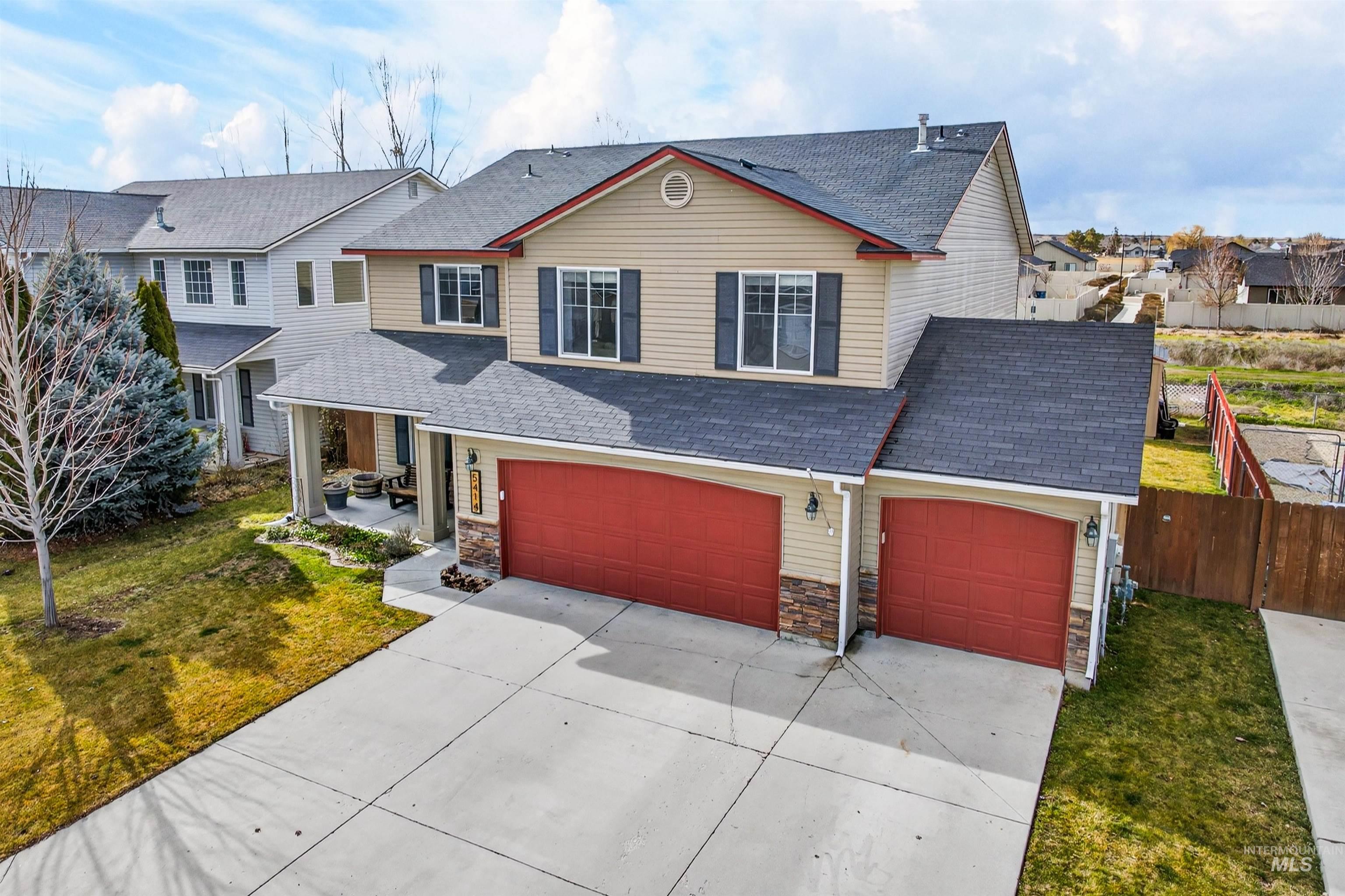 5414 Barkley Way Caldwell, ID 83607 - Photo 40 of 50 Traditional home featuring driveway, roof with shingles, a garage, stone siding, and a residential view