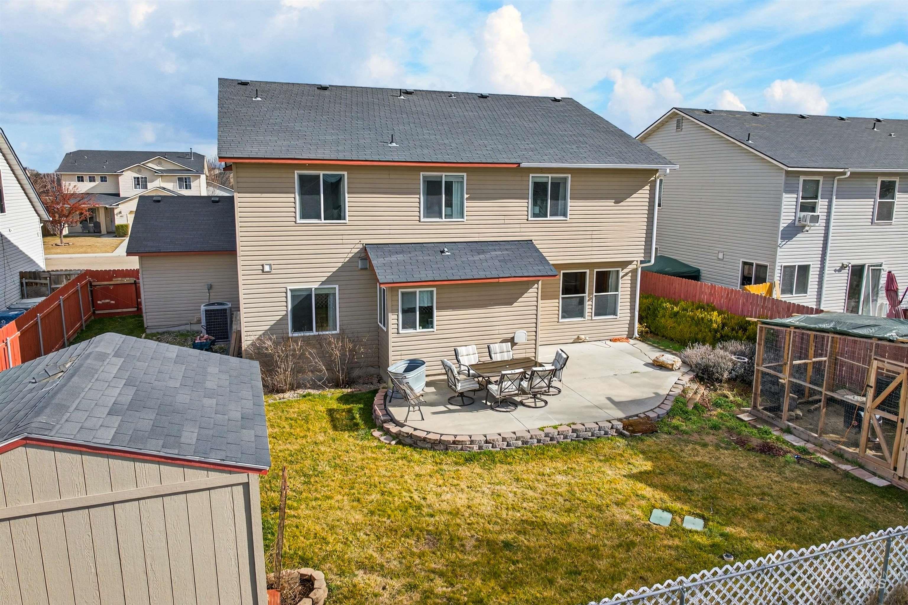 5414 Barkley Way Caldwell, ID 83607 - Photo 45 of 50 Rear view of property with a patio area, a fenced backyard, an outbuilding, a residential view, and a shingled roof