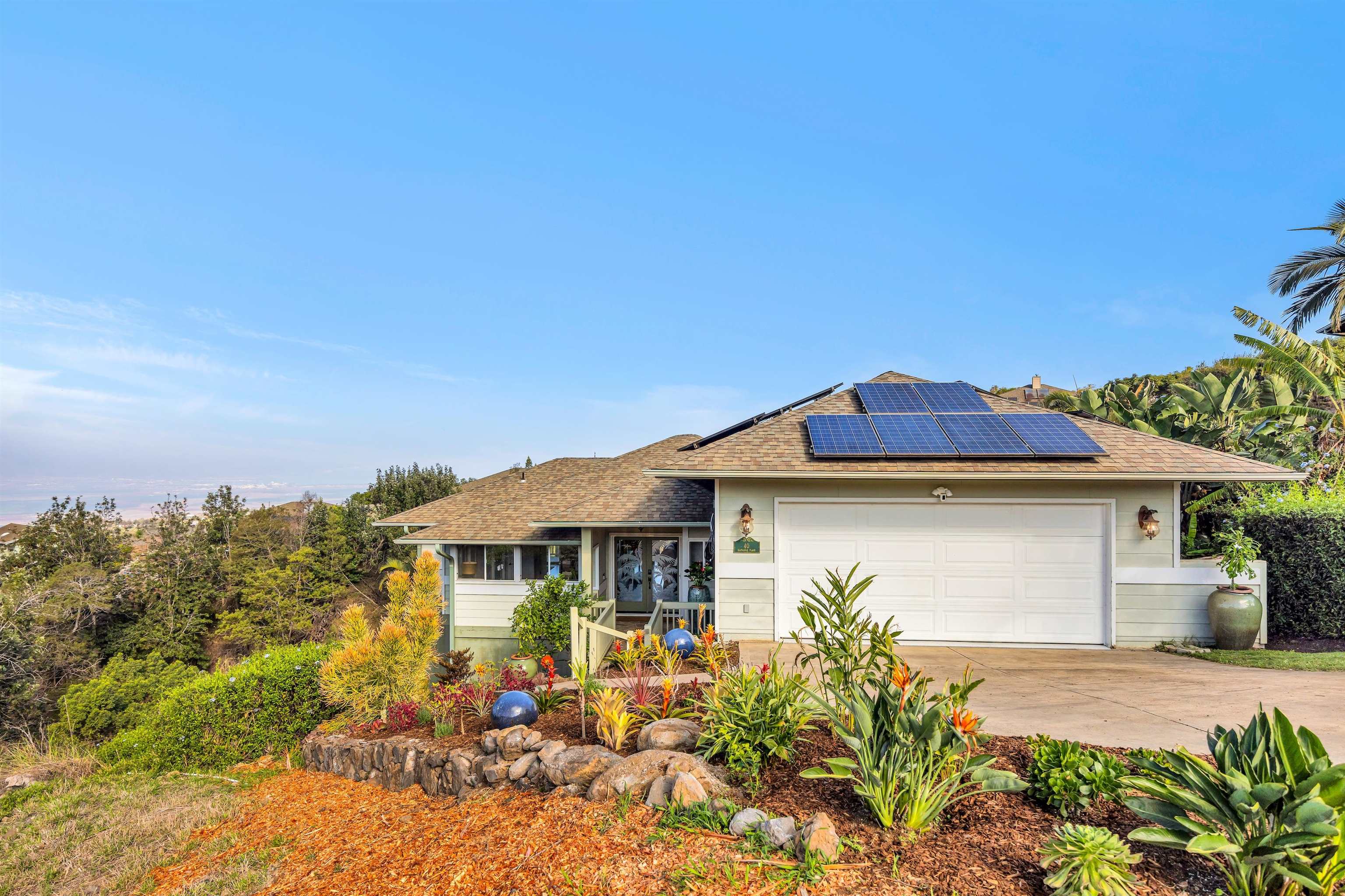 a front view of a house with garden