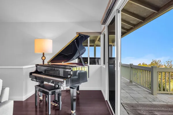 a view of balcony with wooden floor and chair