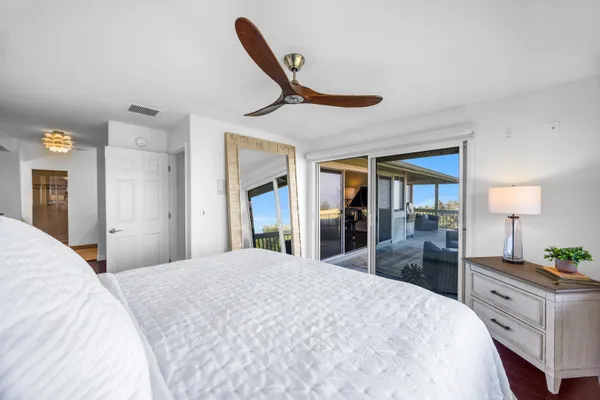 a bedroom with a bed and a large mirror with dresser