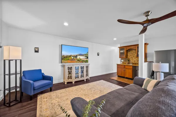 a bedroom with furniture and a wooden floor