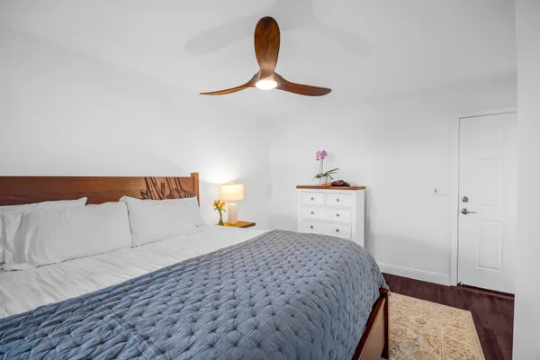a bedroom with a bed and a wooden floor