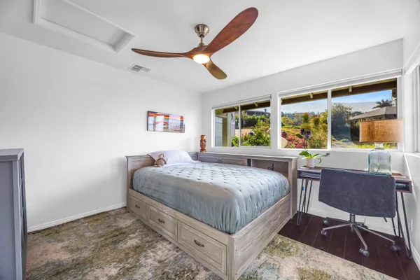 a bedroom with a bed a table and chair