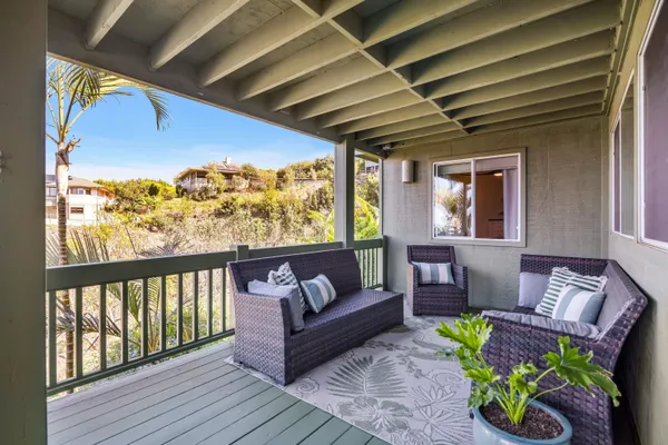 a outdoor living room with furniture and a potted plant