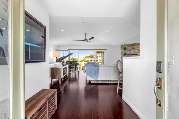 a living room with furniture and a wooden floor