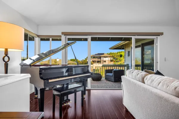 a living room with furniture a ceiling fan and a wooden floor