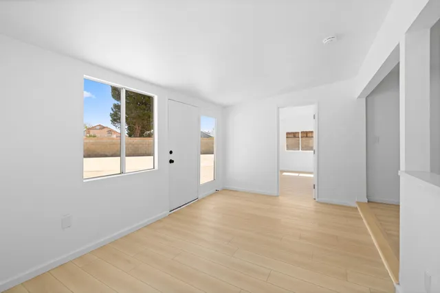 a view of a bedroom with a bed and window