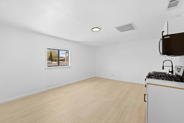a kitchen with stainless steel appliances a stove top oven and a refrigerator