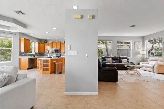 a kitchen with stainless steel appliances granite countertop a stove a refrigerator a sink a oven and a refrigerator