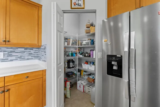a spacious bathroom with a granite countertop sink a toilet a mirror and shower