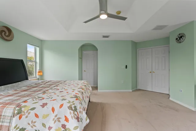an empty room with a ceiling fan and window