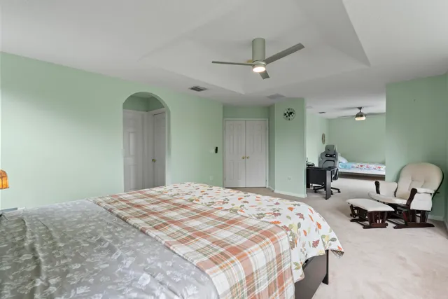 a view of a room with a ceiling fan and closet