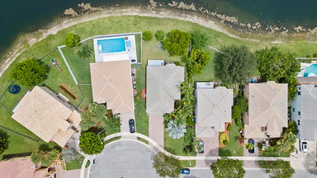 an aerial view of residential houses with outdoor space and street view
