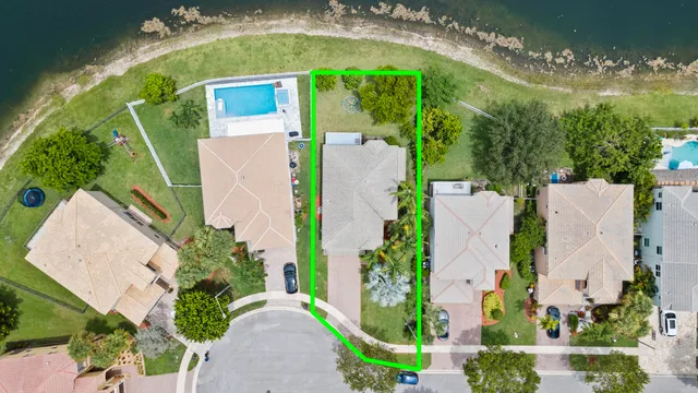 an aerial view of residential houses with outdoor space and lake view