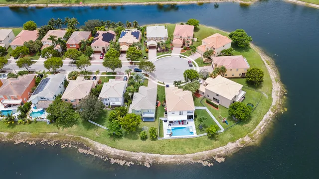 a aerial view of a house with swimming pool and a yard