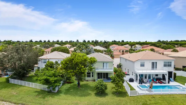 an aerial view of a house with a yard and lake view