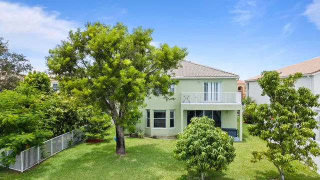 an aerial view of residential houses with outdoor space and lake view