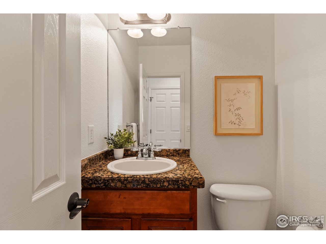 6117 Gold Dust Road Timnath, CO 80547 - Photo 17 of 43 a bathroom with a sink and a mirror