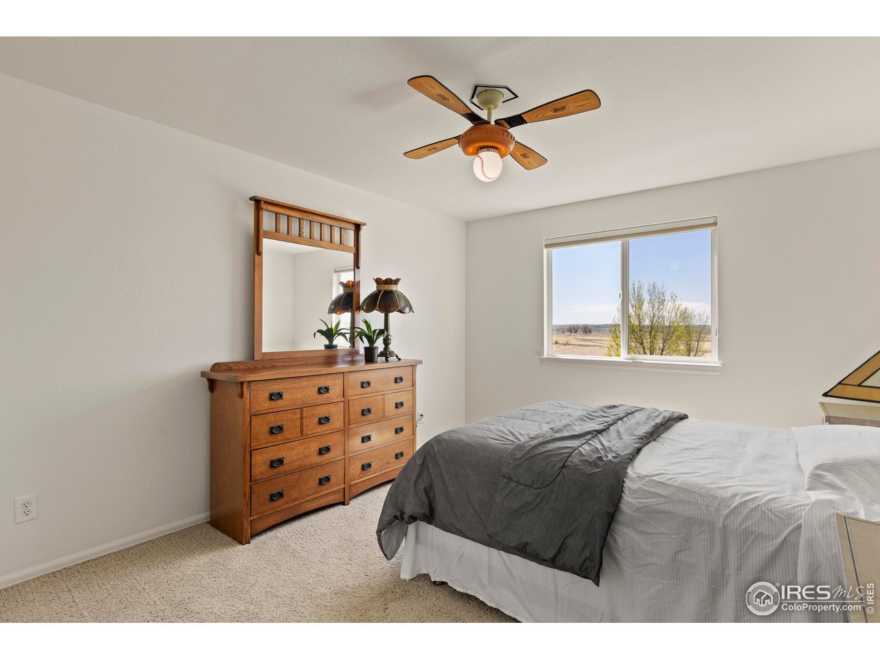 6117 Gold Dust Road Timnath, CO 80547 - Photo 22 of 43 a bedroom with a bed and a chandelier
