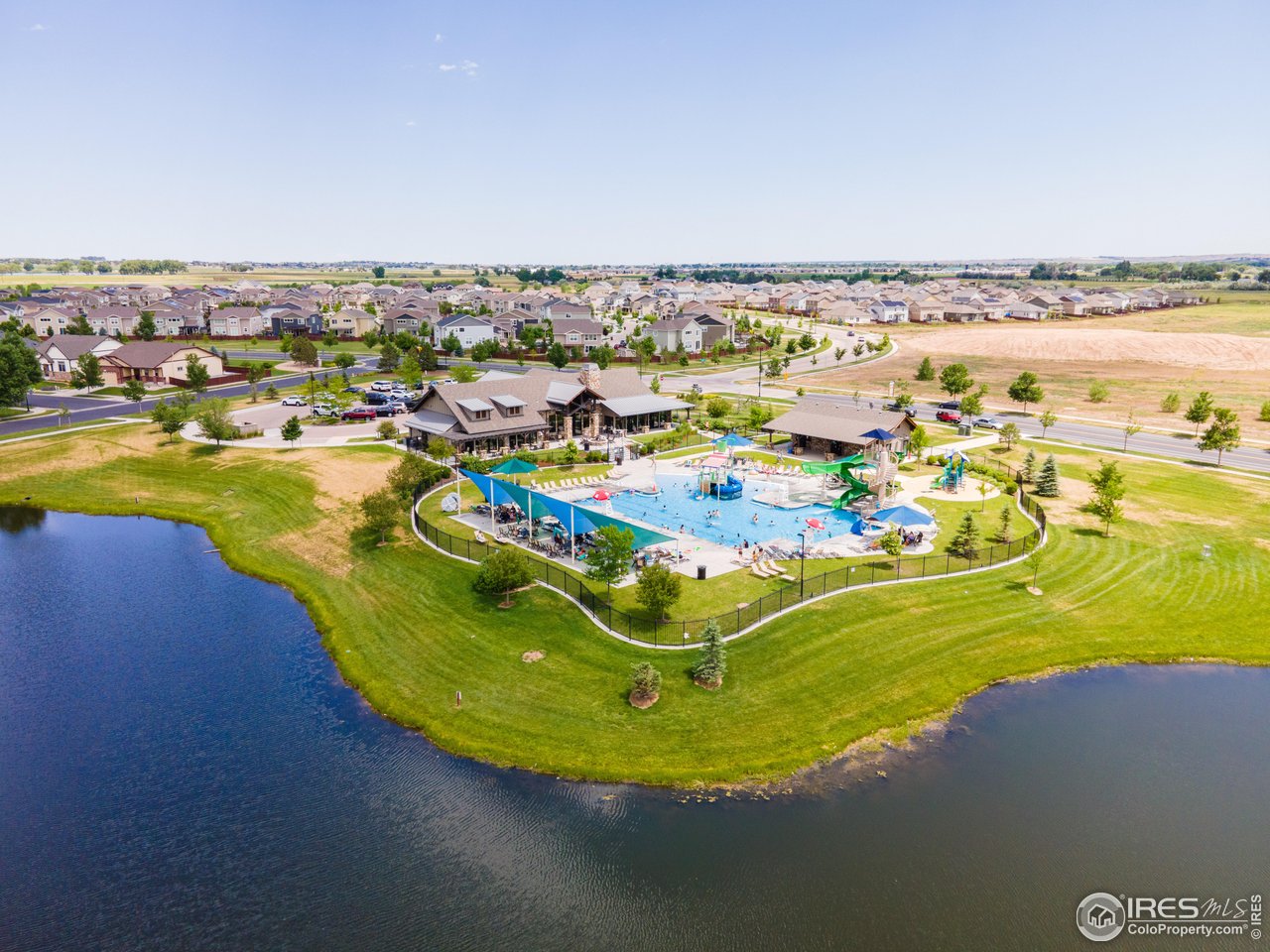 6117 Gold Dust Road Timnath, CO 80547 - Photo 34 of 43 a view of a swimming pool with outdoor seating and yard