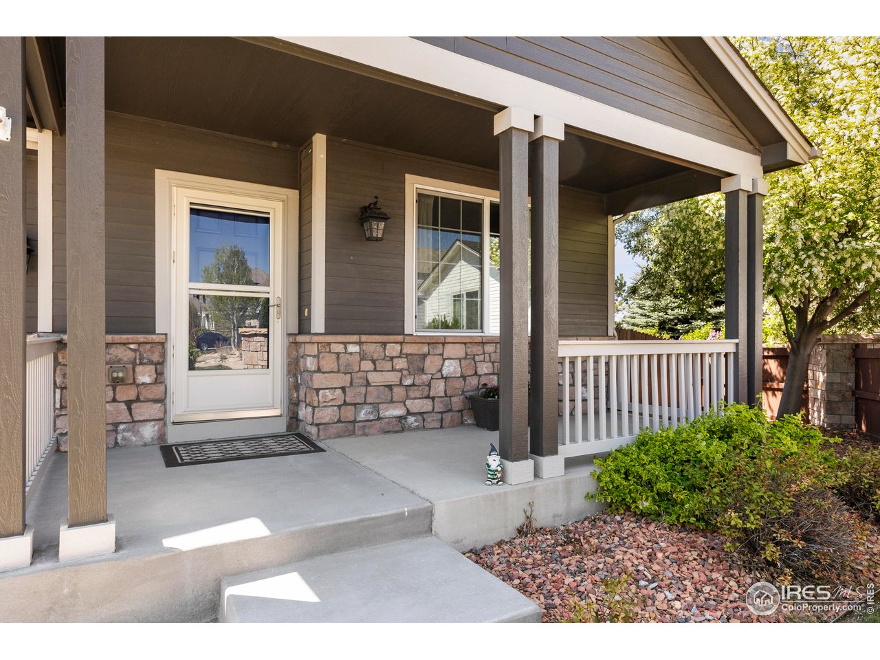 6117 Gold Dust Road Timnath, CO 80547 - Photo 4 of 43 a view of a porch with a table and chairs