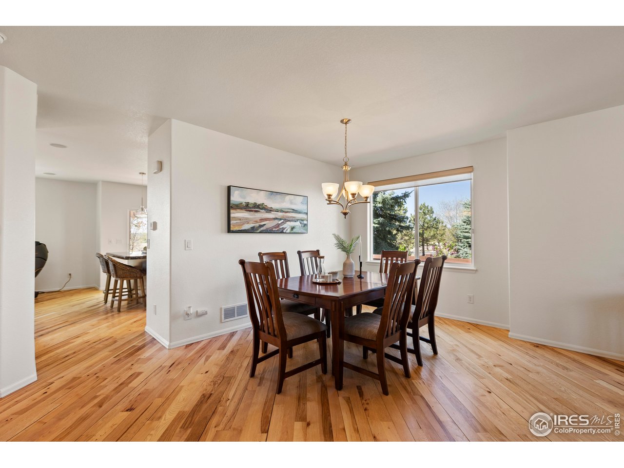 6117 Gold Dust Road Timnath, CO 80547 - Photo 7 of 43 a view of a dining room with furniture window and wooden floor