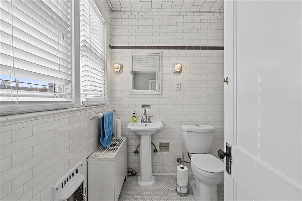 3565 Gerber Avenue Pittsburgh, PA 15212 - Photo 21 of 28 a bathroom with a toilet sink and mirror