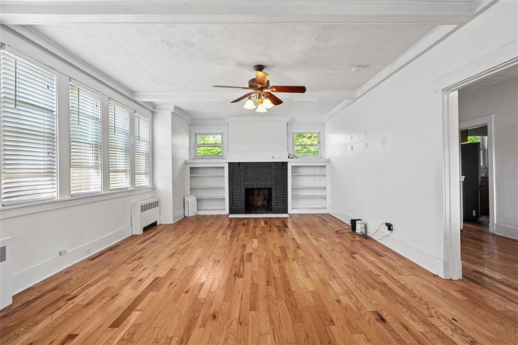 3565 Gerber Avenue Pittsburgh, PA 15212 - Photo 4 of 28 a view of a livingroom with a fireplace a ceiling fan and wooden floor