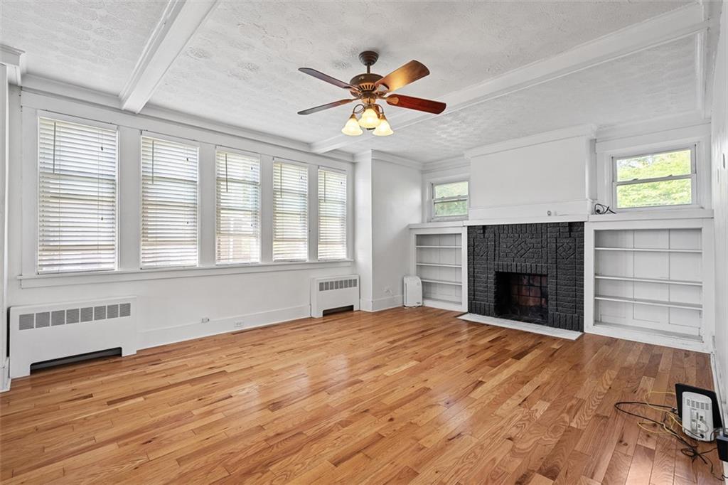 3565 Gerber Avenue Pittsburgh, PA 15212 - Photo 5 of 28 a view of an empty room with a fireplace and a window