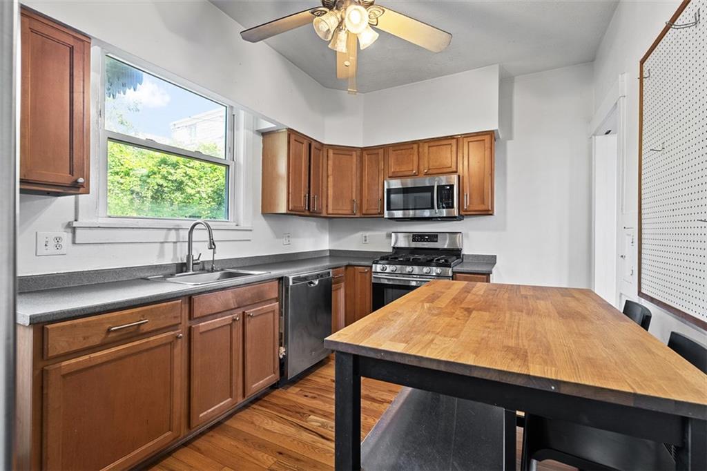 3565 Gerber Avenue Pittsburgh, PA 15212 - Photo 10 of 28 a kitchen with a appliances a sink cabinets and a window
