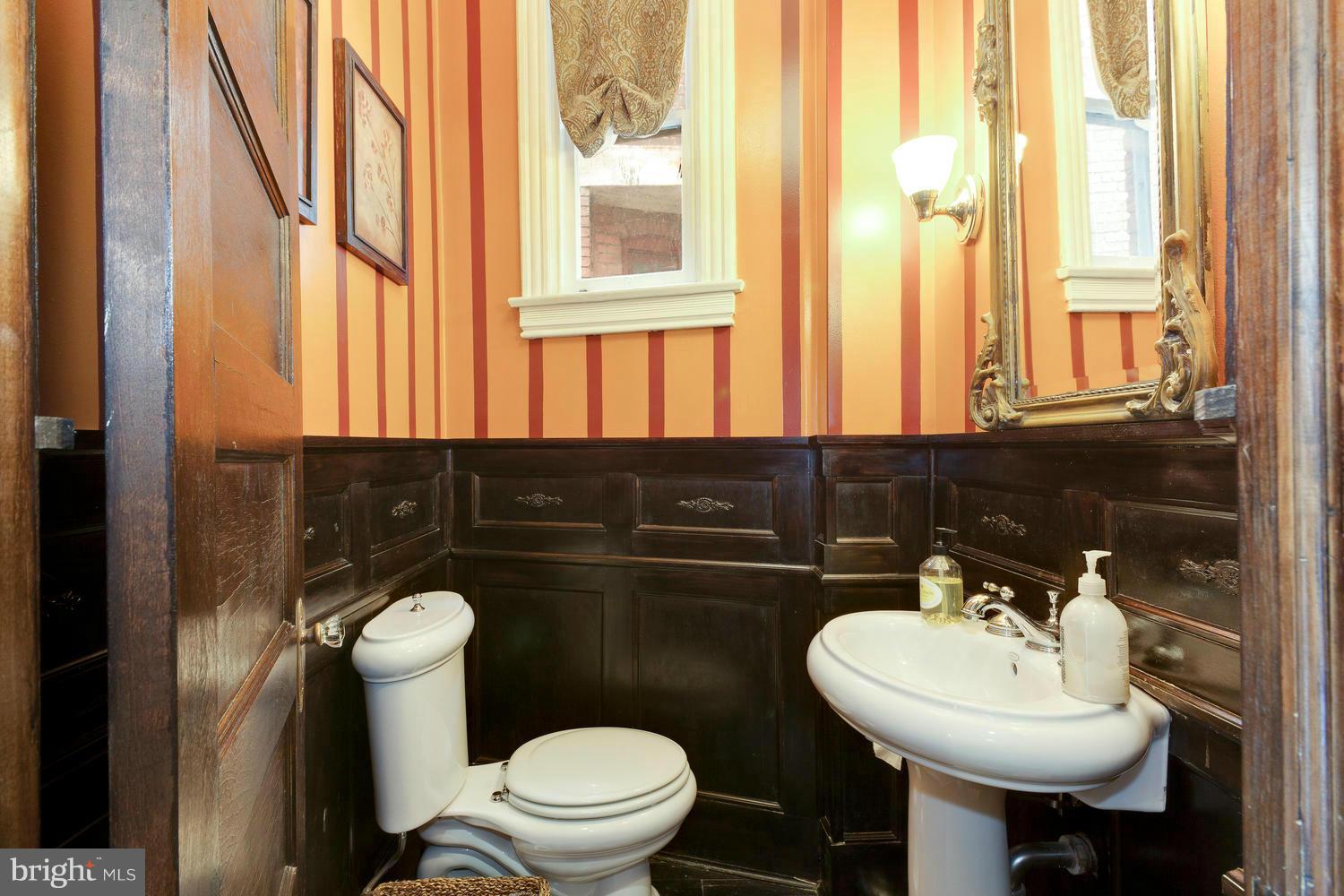 32 R Street Northeast Washington, DC 20002 - Photo 8 of 18 a bathroom with a sink toilet and mirror