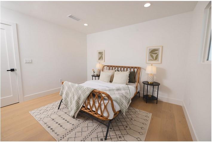 1495 Ancon Street Seaside, CA 93955 - Photo 12 of 35 a bedroom with a bed and wooden floor