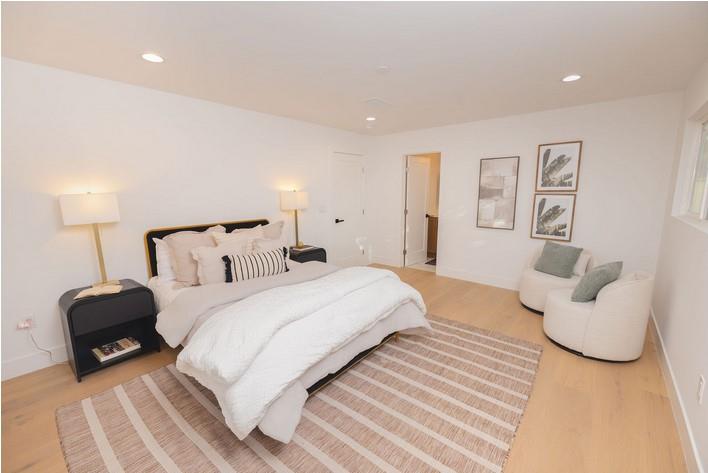 1495 Ancon Street Seaside, CA 93955 - Photo 13 of 35 a spacious bedroom with a bed and a couch