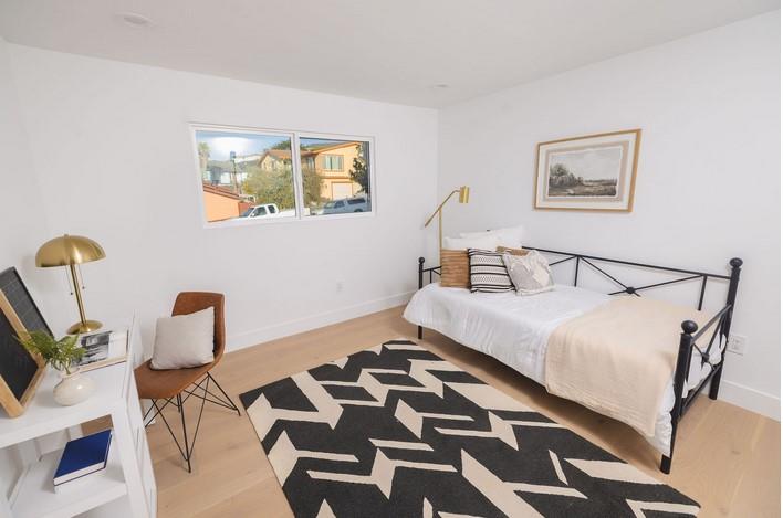 1495 Ancon Street Seaside, CA 93955 - Photo 24 of 35 a bedroom with a bed and wooden floor