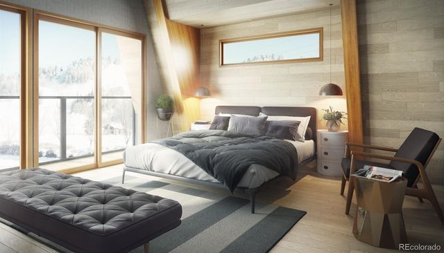 a bedroom with furniture and a large window