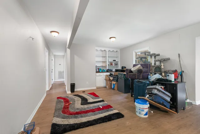 a living room with furniture and a gym equipment