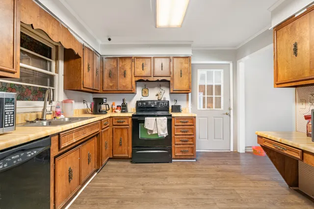 a kitchen with granite countertop stainless steel appliances and wooden cabinets