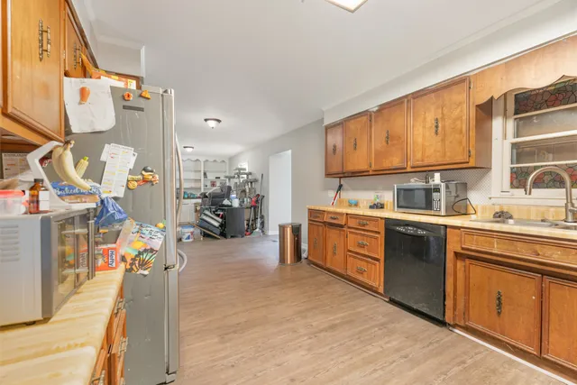 a kitchen with stainless steel appliances sink stove and cabinets