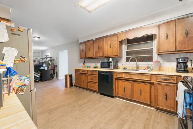 a kitchen with stainless steel appliances granite countertop a stove sink and cabinets
