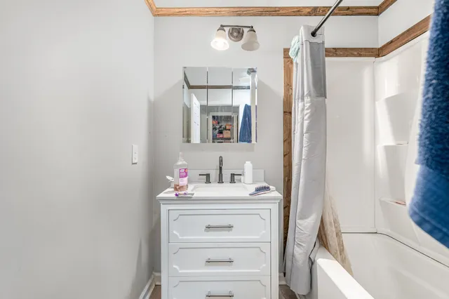 a bathroom with a sink vanity and a mirror