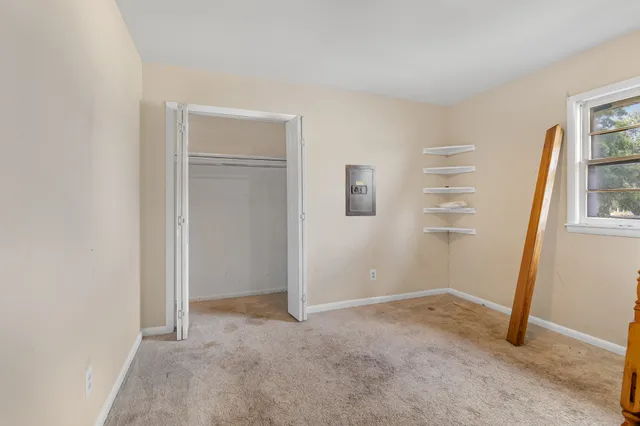 an entryway with an empty room and a window