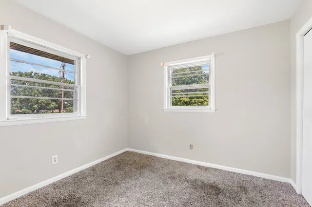 a bathroom with a double vanity sink mirror and toilet