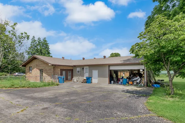 a view of a house with a garden and pathway